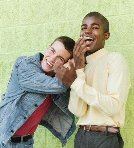 Two Men holding hands and laughing